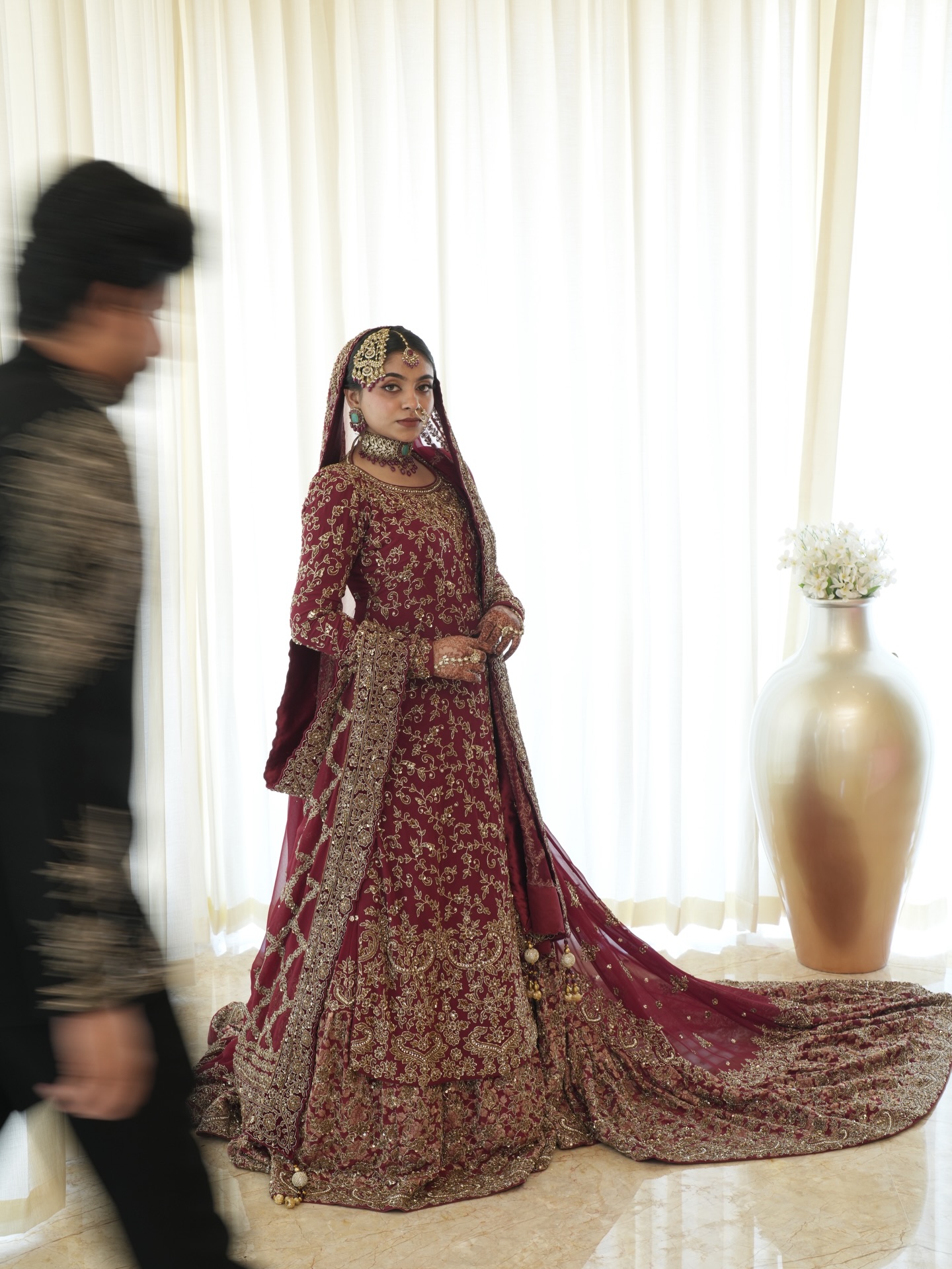 Muslim bride in a deep maroon embroidered gown