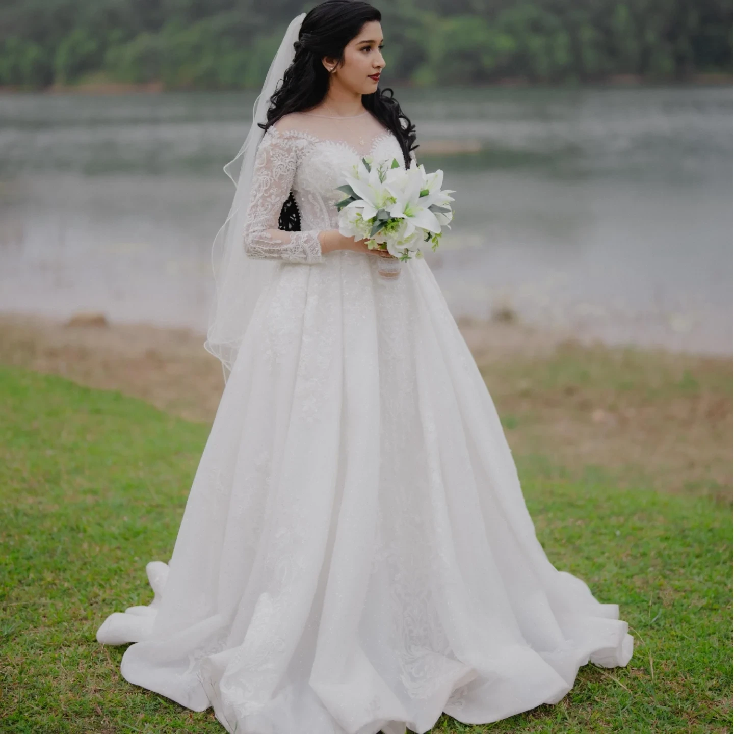 Christian bride in a white lace gown with cathedral veil