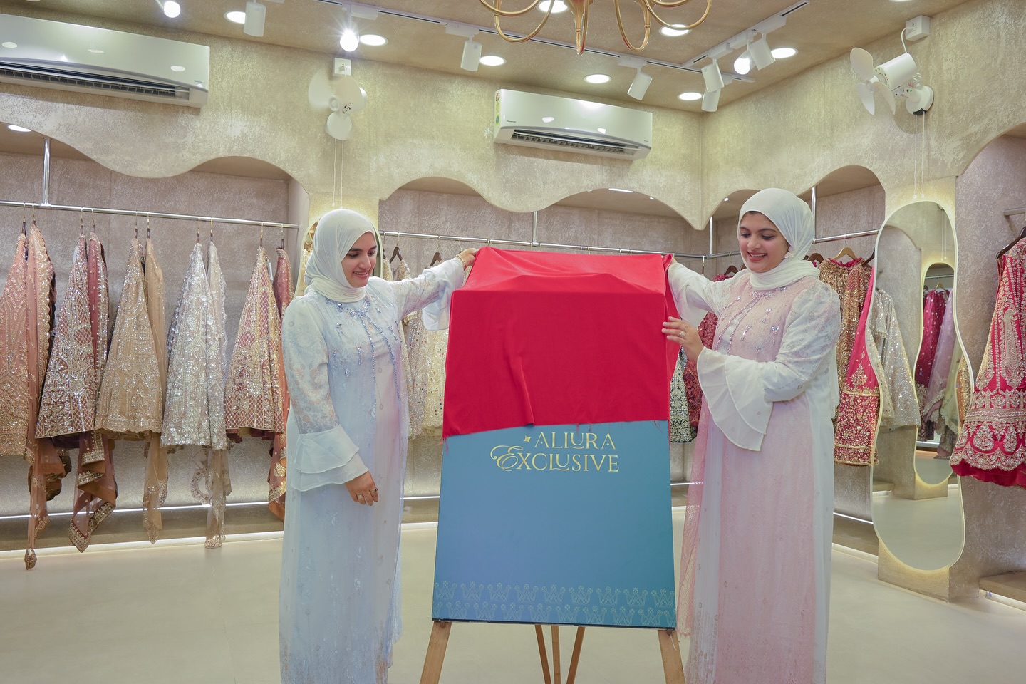 Inside the Allura showroom — staff unveiling a new collection